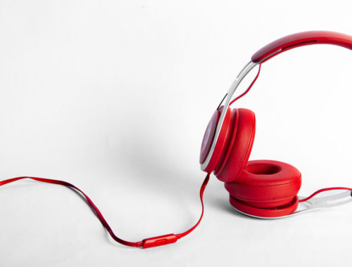 Red headphones against a white background
