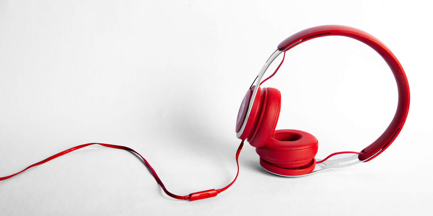 Red headphones against a white background